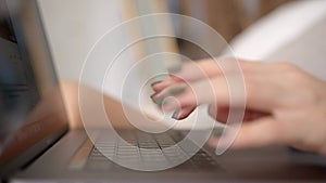 Woman using laptop, click on touchpad and type on keyboard