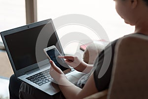 Woman using laptop computer in house