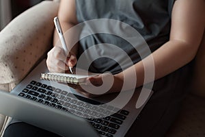 Woman using laptop computer in house