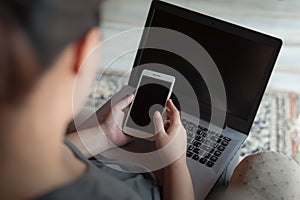 Woman using laptop computer in house