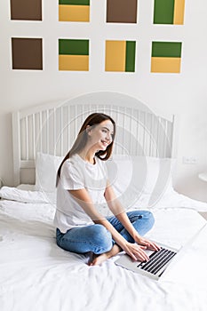 Woman Using Laptop Computer Lying On Bed. Closeup Portrait Of Happy Beautiful Girl Typing On Notebook Keyboard, Working Online At