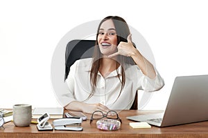 woman using laptop and doing talking on the telephone gesture.