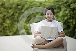 Woman using laptop in garden,work from home concept