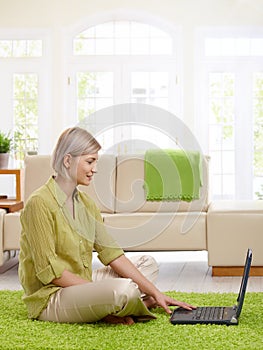 Woman using laptop at home