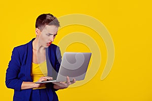 Woman using laptop looking at computer screen blown away in stupor