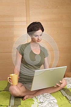 Woman using laptop in morning