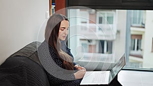 Woman using laptop for online psychotherapy session, talking with psychologist via video chat