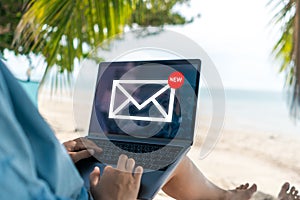 Woman using laptop and it`s show email recieve notification icon