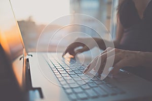 Woman using laptop, searching web, browsing information, having workplace at home photo