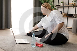 Woman using laptop for stretching