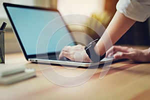 Woman using laptop on table in office room, for graphics display montage.