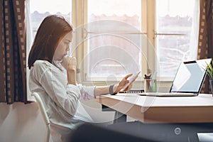 Woman using laptop on table in office room, for graphics display montage.