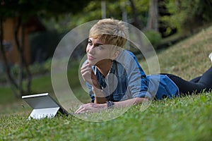 Woman using a laptop tablet outdoors