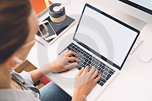 Woman using laptop with white blank screen, mockup