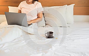 A woman using laptop working from home,