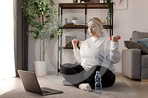 Woman using laptop for workout