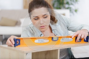 woman using leveling tool