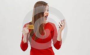 Woman using on line banking with credit card and smart phone