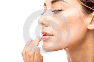 Woman Using Lip Balm In Studio