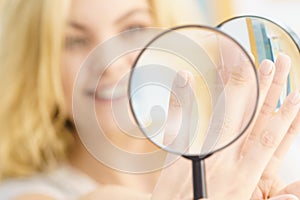 Woman using magnifer on nails