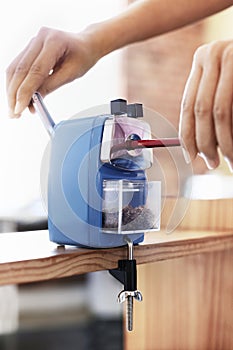 Woman Using Manual Pencil Sharpener