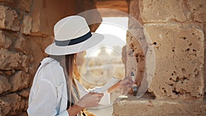 Woman using map and brush during archeological expedition