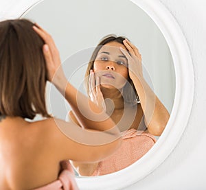 Woman using mirror