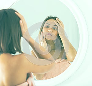 Woman using mirror
