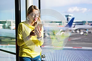 Woman using mobile phone in airport