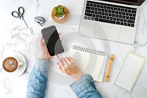 Woman using mobile phone application with computer laptop. flat lay and modern style