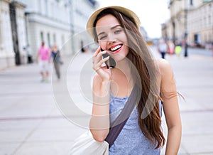 Woman using mobile phone on city street