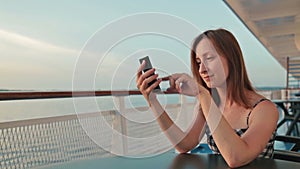 Woman using mobile phone on cruise ship