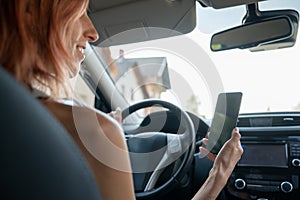 Woman using mobile phone while driving