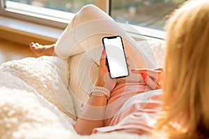 Woman using mobile phone with empty white screen