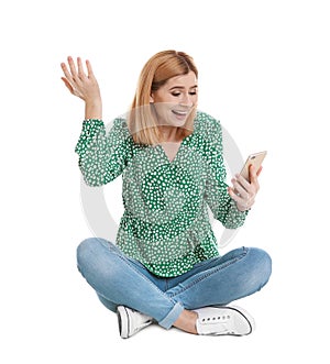 Woman using mobile phone for video chat on white