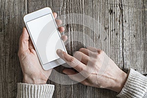 Woman using mobile phone on wooden table