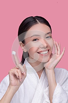 Woman using moisturising cream for her face
