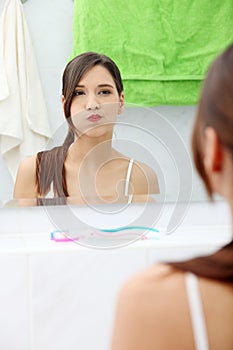 Woman using mouthwash