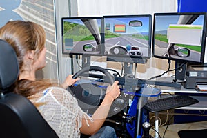 Woman using multi screened driving simulator