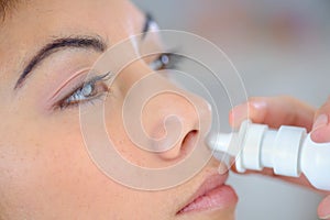 Woman using nasal spray