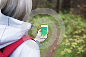 Woman using navigation app on smartphone photo