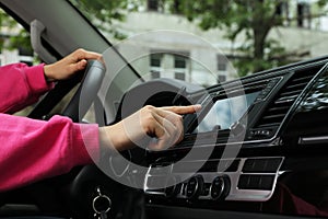 Woman using navigation while driving car, closeup