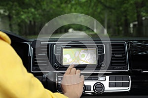 Woman using navigation system while car, closeup
