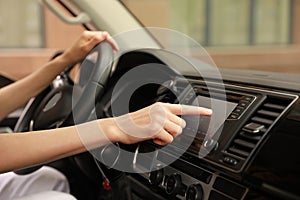 Woman using navigation system while driving car