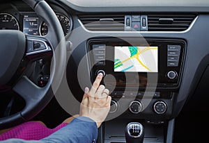 Woman using navigation system while driving a car