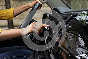 Woman using navigation system while driving car, closeup