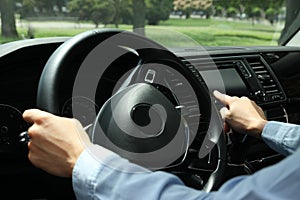 Woman using navigation system while driving car, closeup