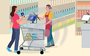 Woman using NFC technology to pay for her shopping at the supermarket