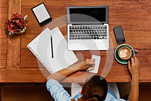 Woman Using Notebook Computer, Taking Notes At Cafe. Working.