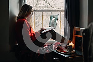 Woman using online dating app on laptop. Valentines Day During The Coronavirus Outbreak. Love at distance, loneliness in